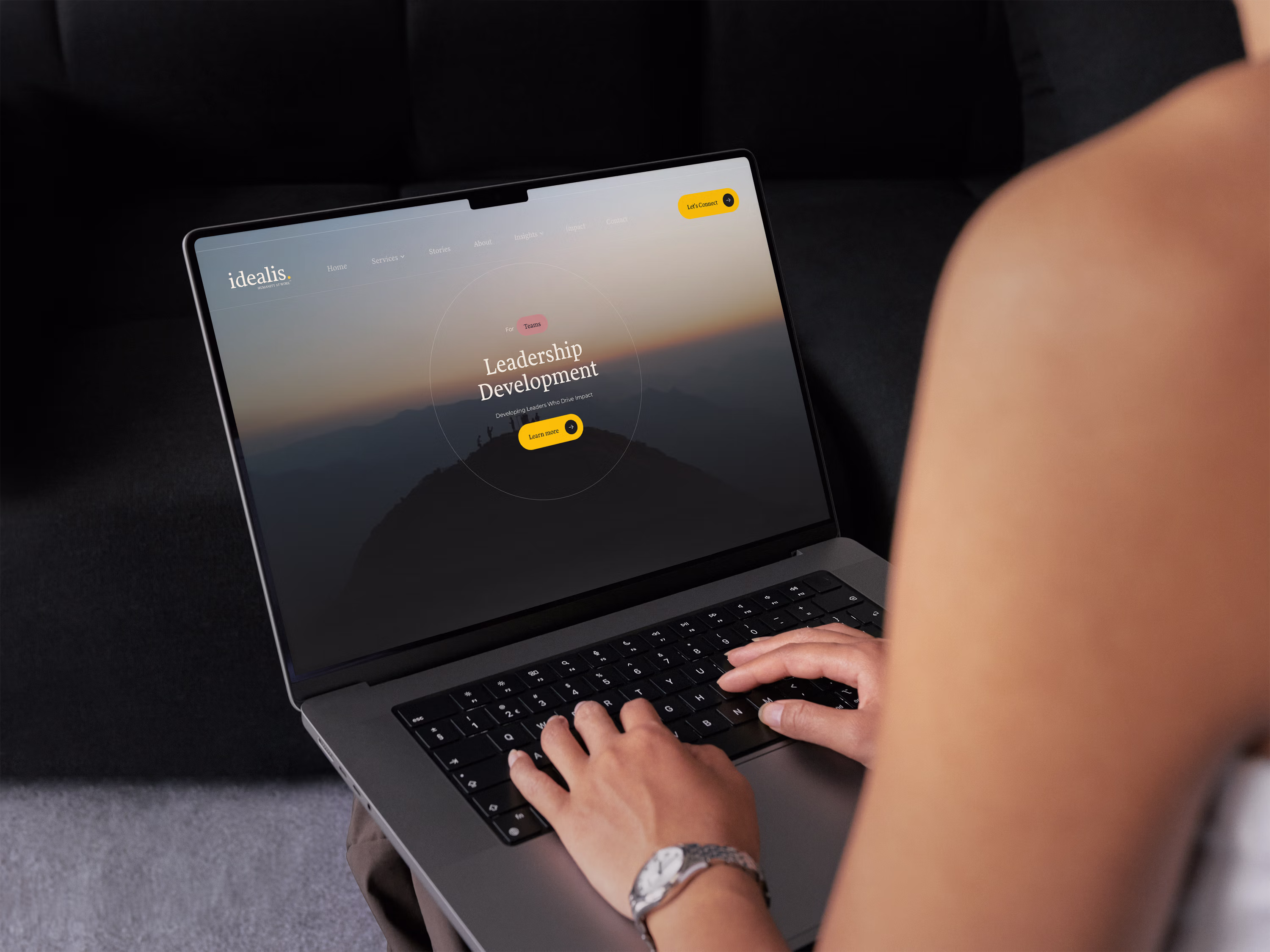 Idealis Advisory website on MacBook mockup — live desktop view